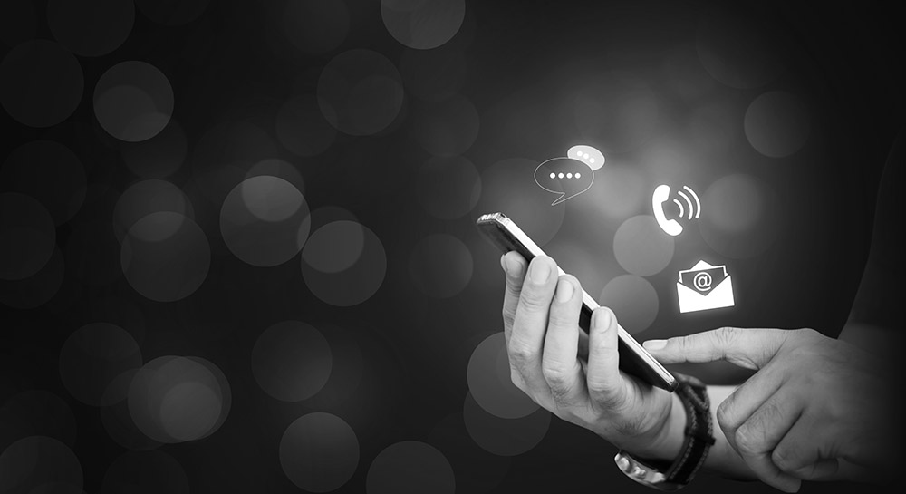 CONTACT US, Hand of a businessman holding a mobile smartphone with the icon. Contact us connection concept with copy space. UK EU Sanctions